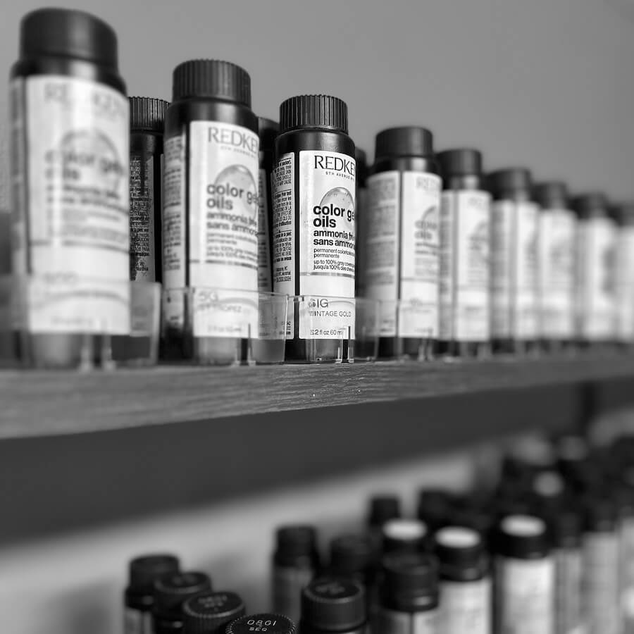Black and white photo of professional hair products on shelf